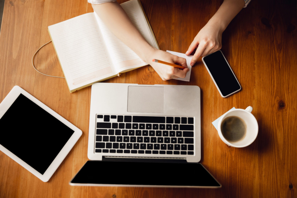 Close up of caucasian female hands during working in office, studying, top view